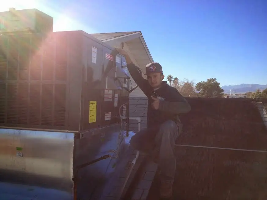 HVAC technician performing HVAC Inspection on a rooftop unit in Southampton